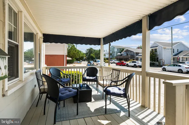 a living room with furniture a flat screen tv and a floor to ceiling window