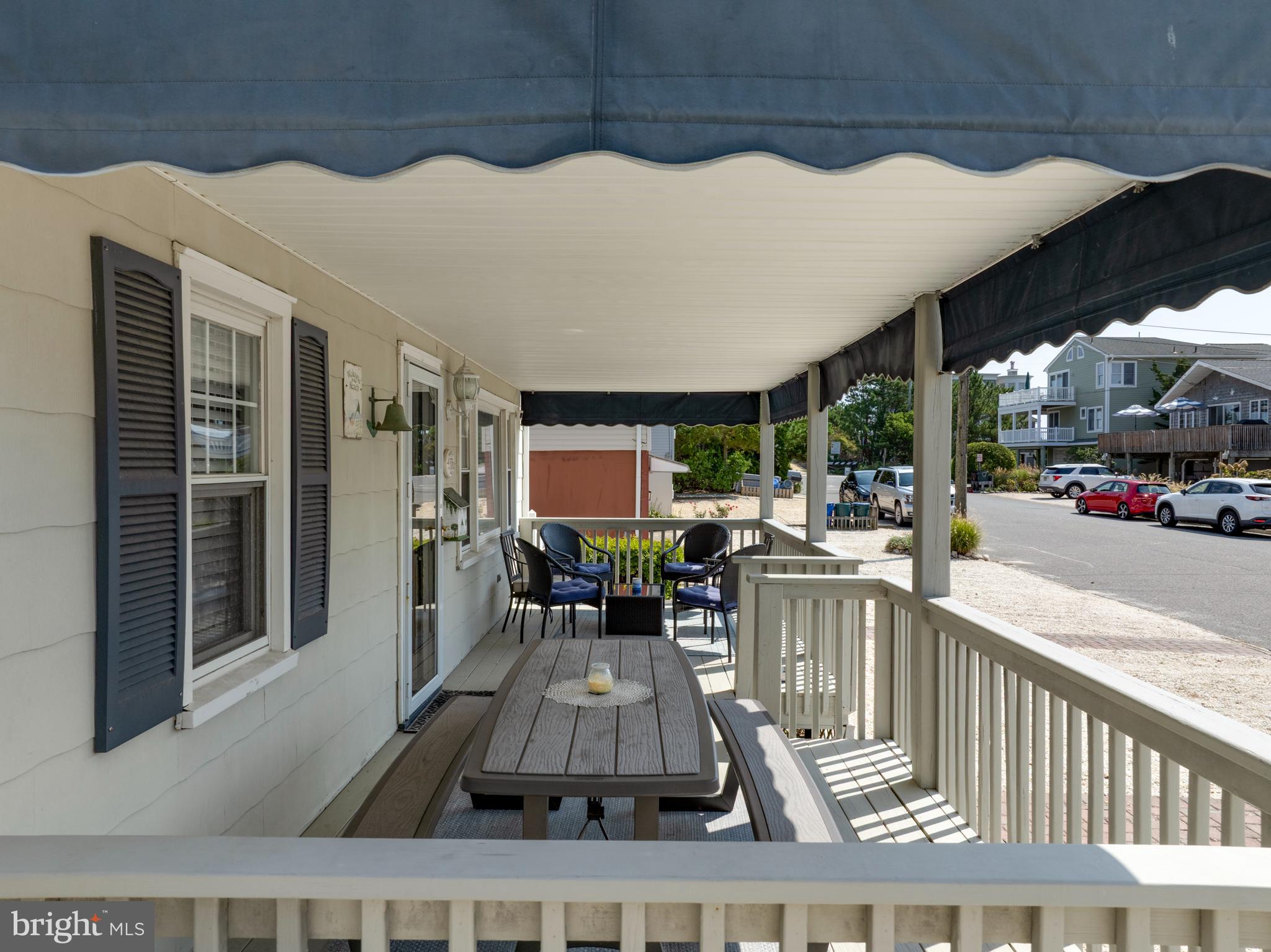33 19th Street Surf City, NJ 08008 - Photo 9 of 63 a living room with furniture a flat screen tv and a floor to ceiling window