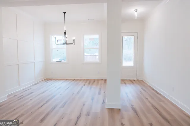 a view of a room with wooden floor and windows
