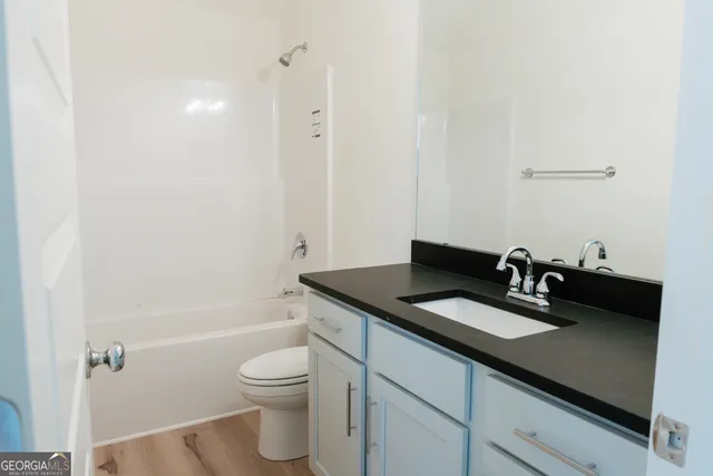 a view of empty room with fireplace and fan