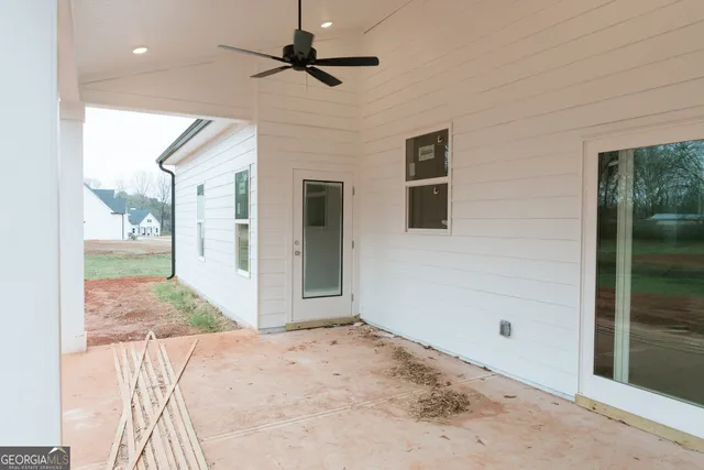 a view of empty room with fireplace and wooden floor