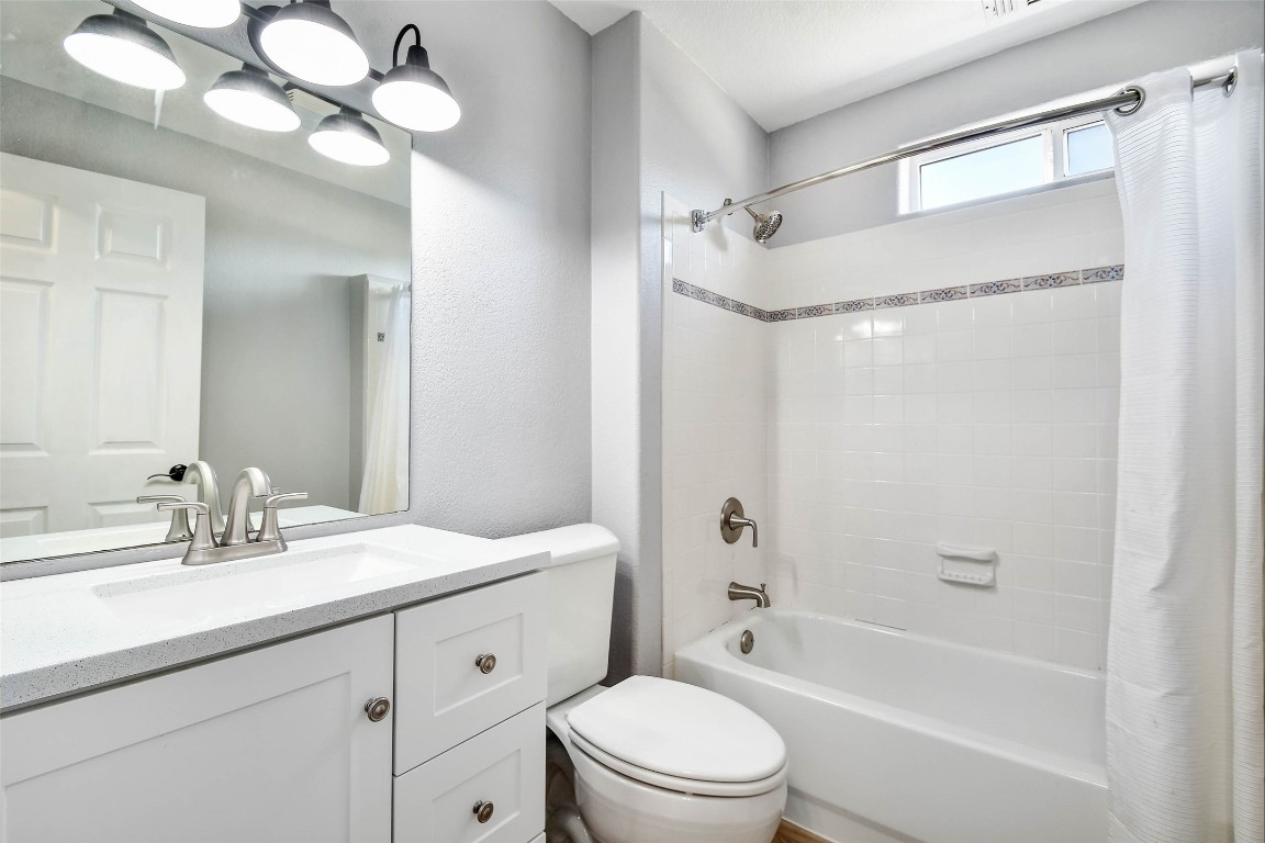 1265 Bob White Drive Spring Branch, TX 78070 - Photo 19 of 25 a bathroom with a sink a toilet a mirror and shower