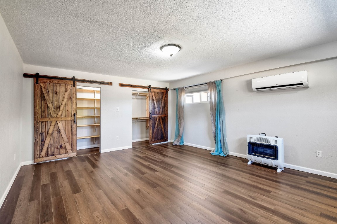 1265 Bob White Drive Spring Branch, TX 78070 - Photo 22 of 25 an empty room with wooden floor closet and windows