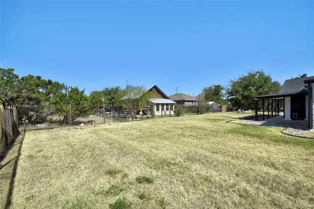 a view of a house with a yard and sitting area