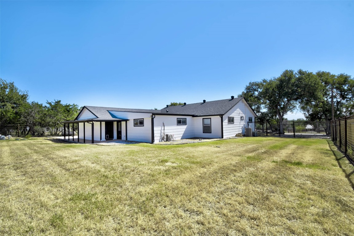 1265 Bob White Drive Spring Branch, TX 78070 - Photo 24 of 25 a front view of house with yard and trees in the background