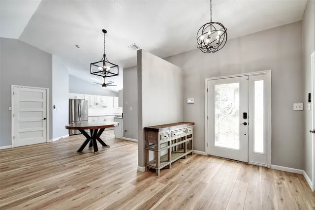 a view of a livingroom with furniture wooden floor and a chandelier
