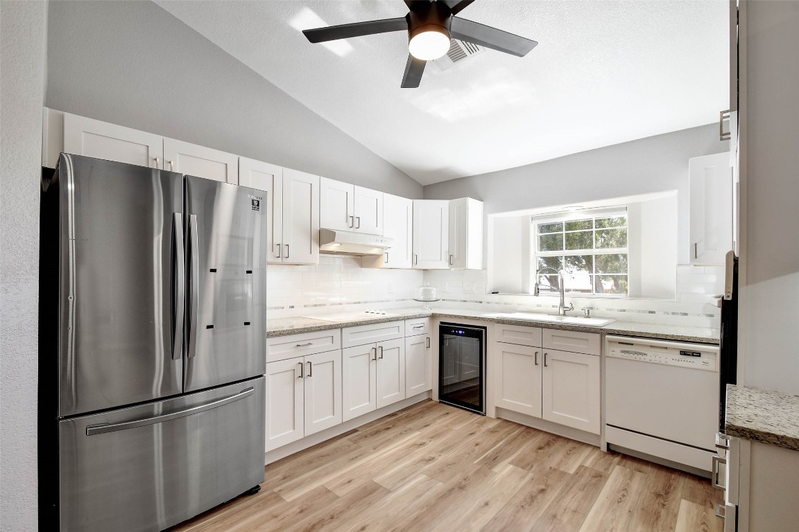 1265 Bob White Drive Spring Branch, TX 78070 - Photo 7 of 25 a kitchen with stainless steel appliances granite countertop a refrigerator sink and cabinets