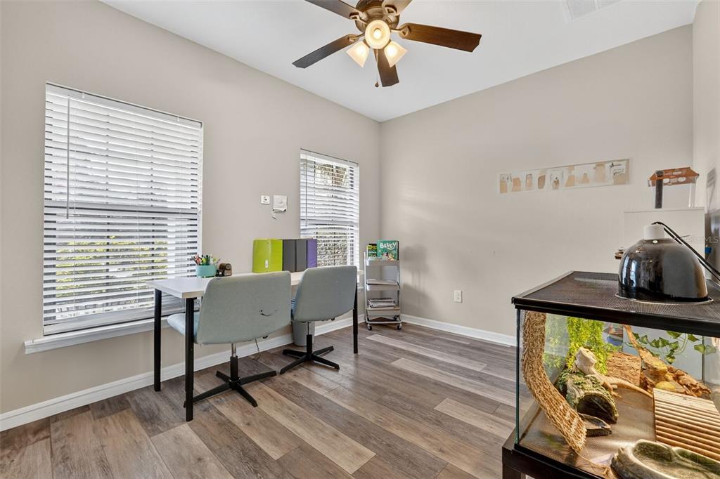 11214 Carrick Stone Street Wimauma, FL 33598 - Photo 12 of 73 a view of a workspace with furniture and a window