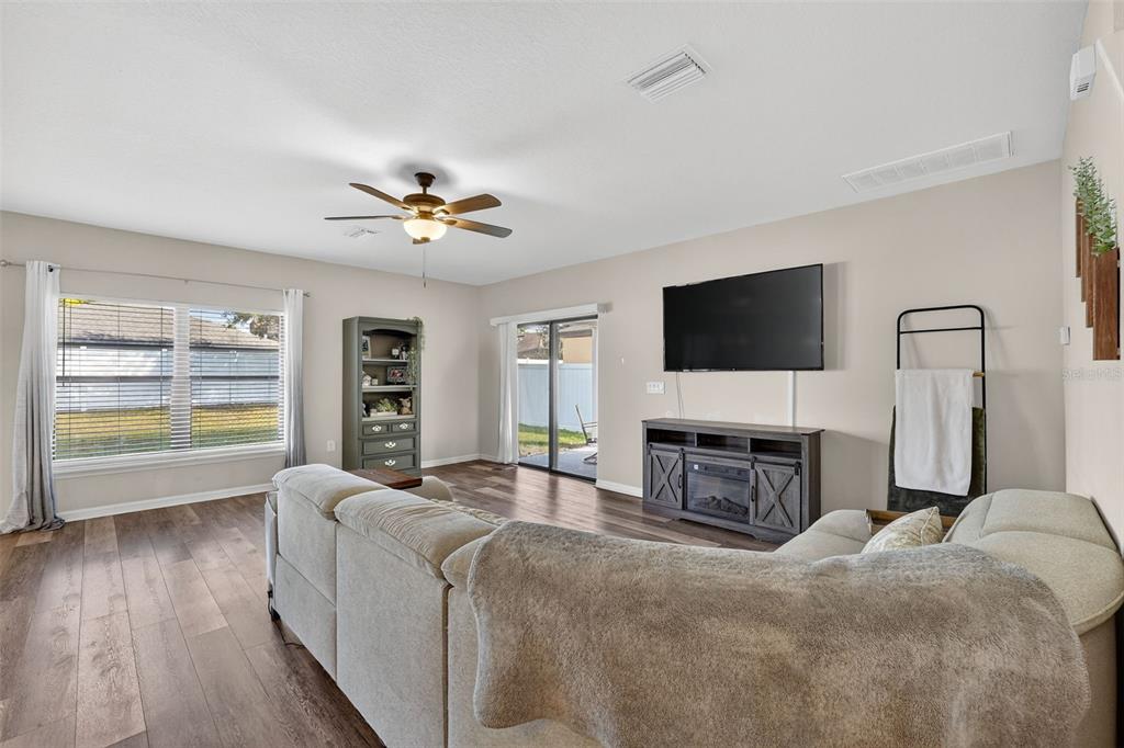 11214 Carrick Stone Street Wimauma, FL 33598 - Photo 15 of 73 a living room with furniture and a flat screen tv
