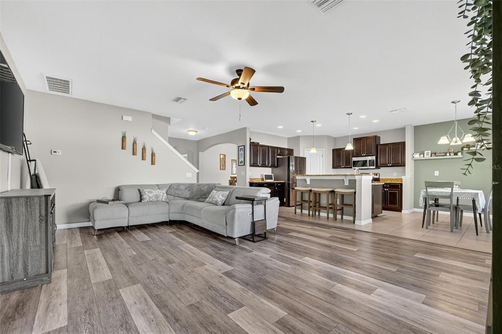 11214 Carrick Stone Street Wimauma, FL 33598 - Photo 18 of 73 a living room with furniture and a wooden floor