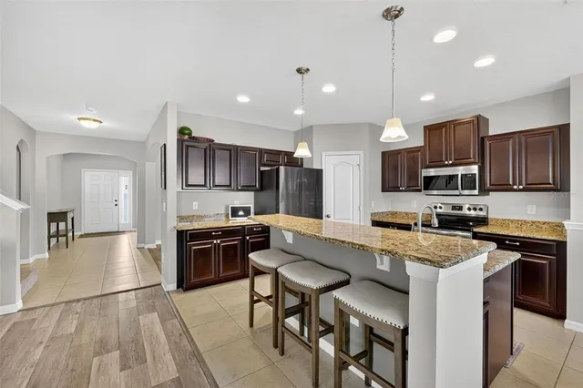 an aerial view of multiple houses with a yard
