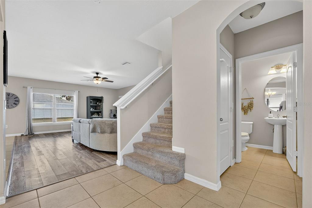 11214 Carrick Stone Street Wimauma, FL 33598 - Photo 27 of 73 a view of a livingroom with furniture and stairs