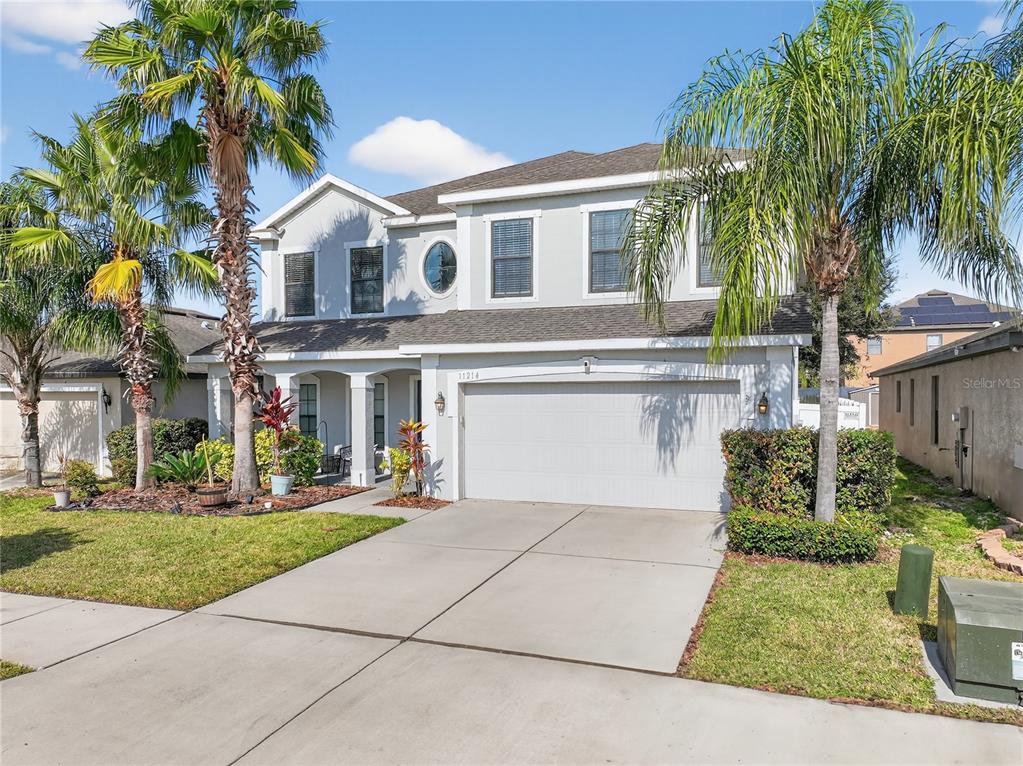 11214 Carrick Stone Street Wimauma, FL 33598 - Photo 4 of 73 a front view of a house with garden