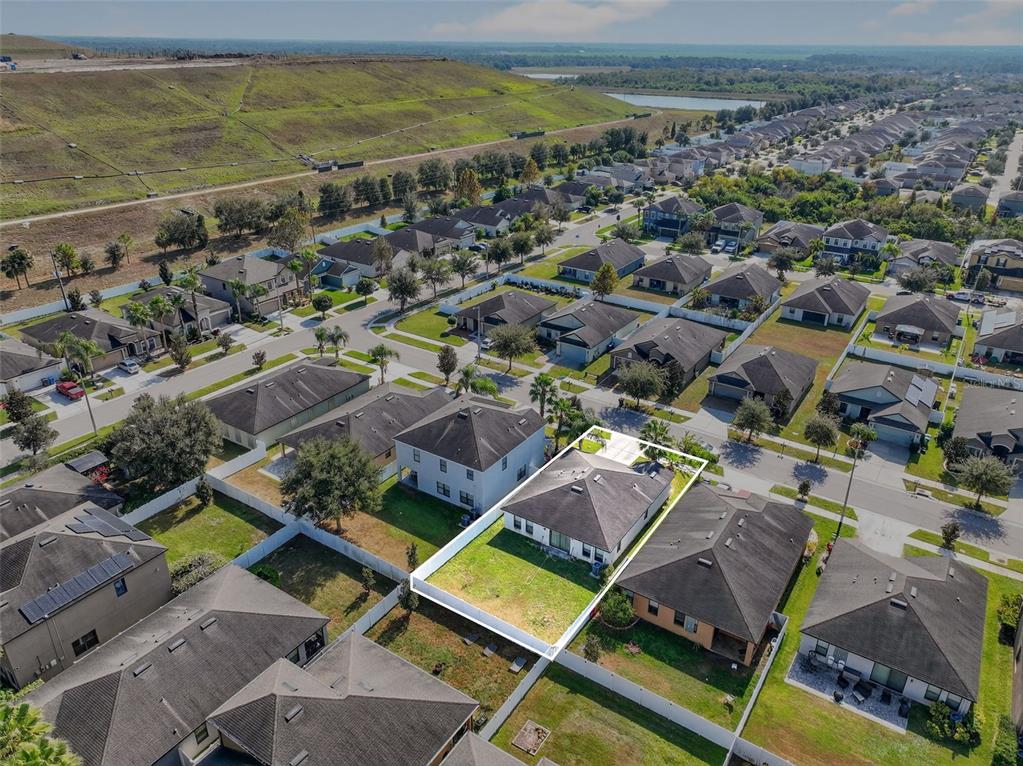 11214 Carrick Stone Street Wimauma, FL 33598 - Photo 60 of 73 an aerial view of residential houses with outdoor space