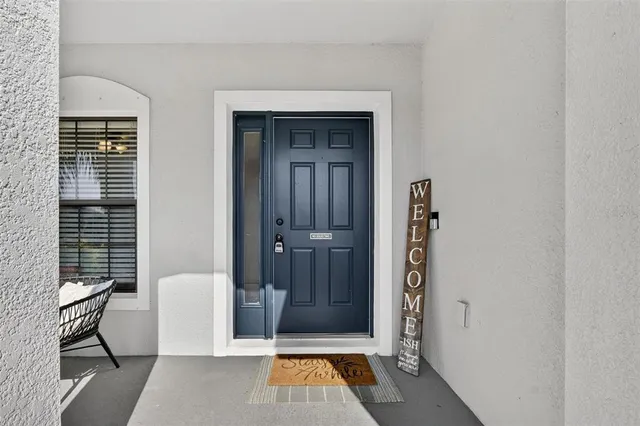 a kitchen with stainless steel appliances kitchen island granite countertop a table chairs microwave and sink