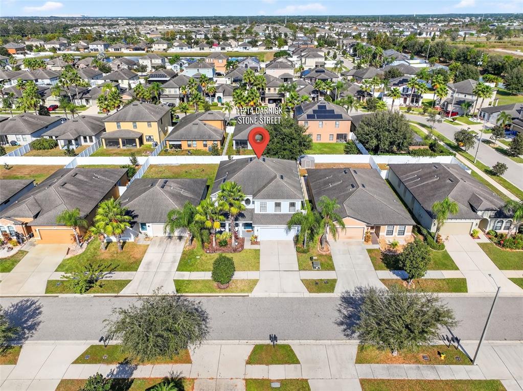 11214 Carrick Stone Street Wimauma, FL 33598 - Photo 62 of 73 an aerial view of residential houses with outdoor space