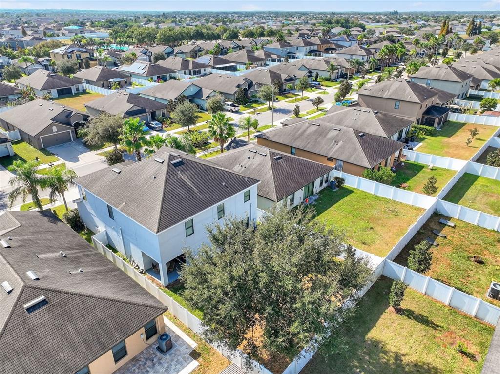 11214 Carrick Stone Street Wimauma, FL 33598 - Photo 65 of 73 an aerial view of a house with a swimming pool