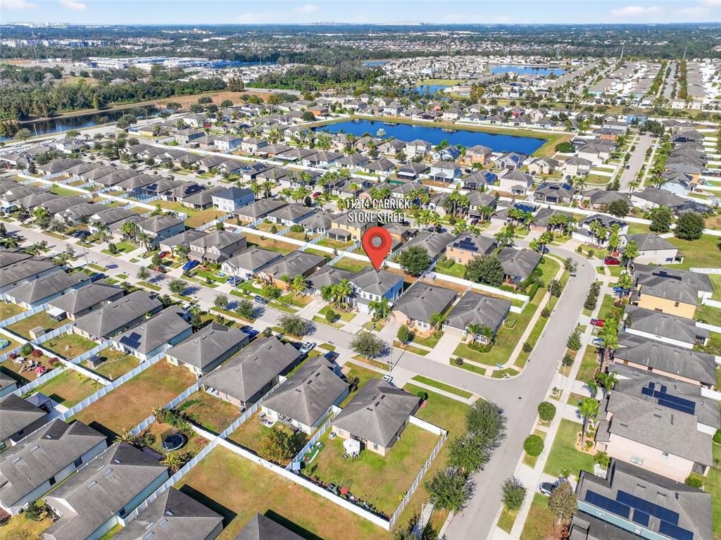 11214 Carrick Stone Street Wimauma, FL 33598 - Photo 66 of 73 an aerial view of residential building with parking space