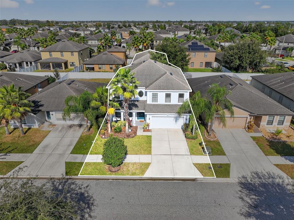 11214 Carrick Stone Street Wimauma, FL 33598 - Photo 67 of 73 an aerial view of multiple houses with a yard