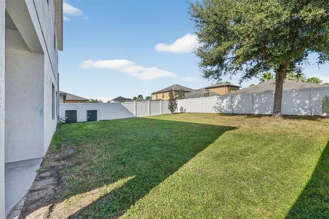 a spacious bedroom with a bed and a chandelier
