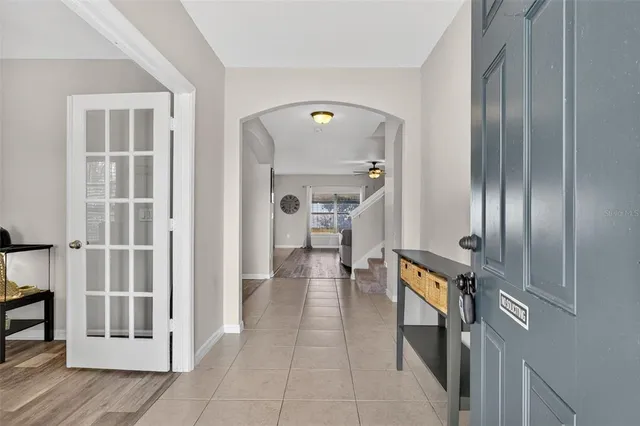 a spacious bedroom with a bed a dresser and a flat screen tv