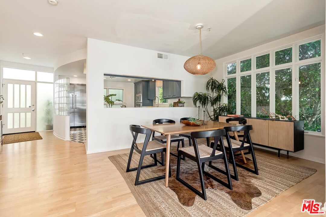 3002 3rd Street, Unit 203 Santa Monica, CA 90405 - Photo 12 of 44 a view of a dining room with furniture wooden floor and chandelier