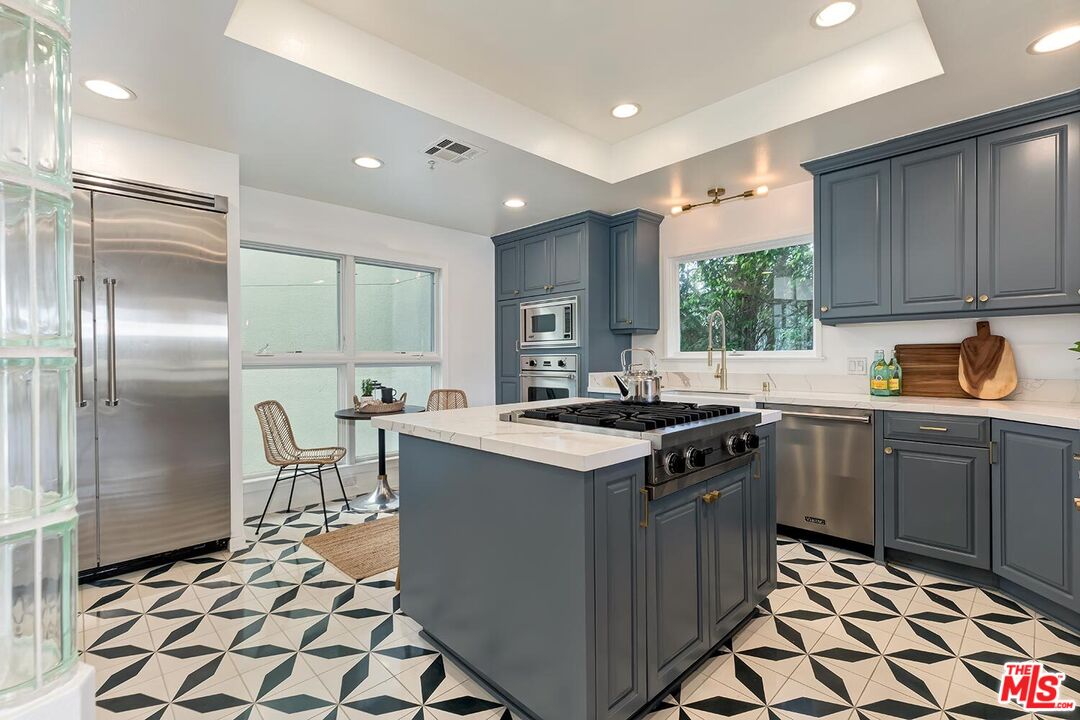 3002 3rd Street, Unit 203 Santa Monica, CA 90405 - Photo 20 of 44 a kitchen with a stove a sink and a refrigerator
