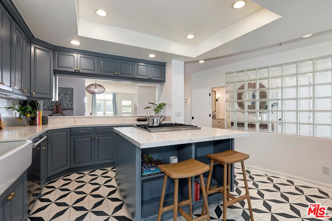 3002 3rd Street, Unit 203 Santa Monica, CA 90405 - Photo 22 of 44 a kitchen with a sink and chairs