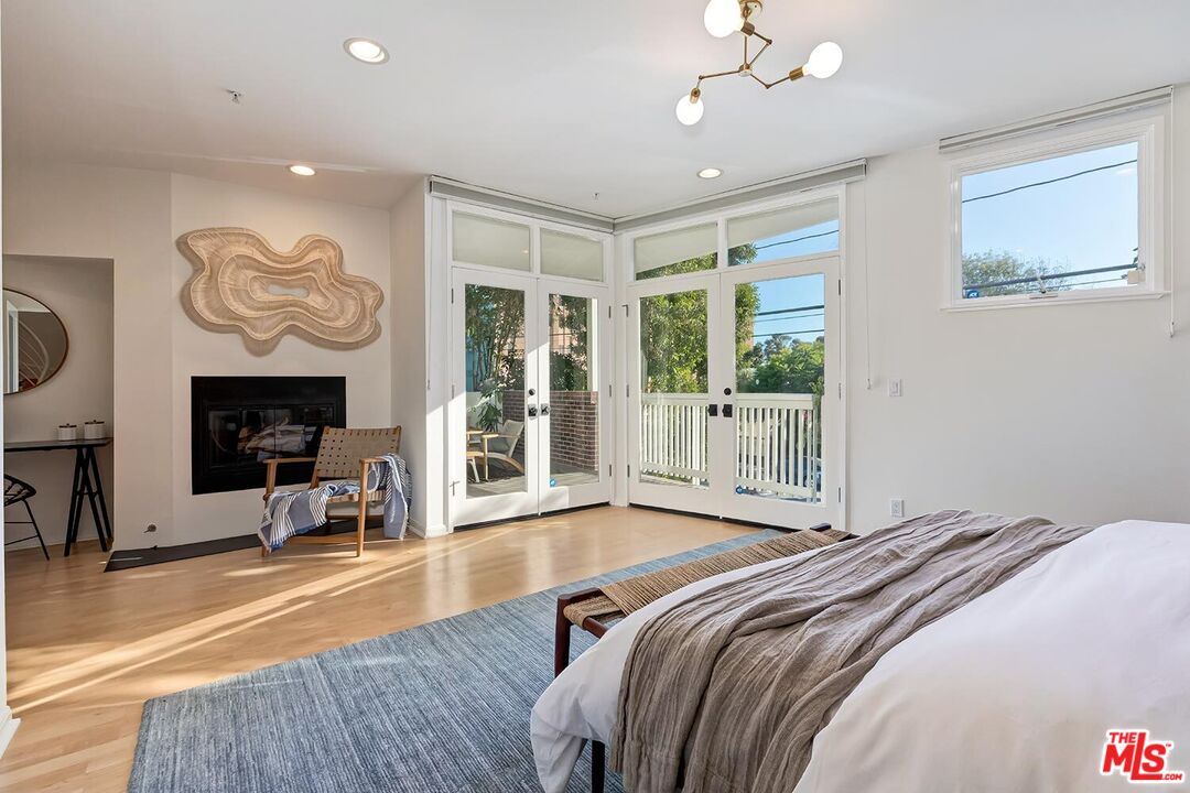 3002 3rd Street, Unit 203 Santa Monica, CA 90405 - Photo 30 of 44 a bedroom with furniture and a fireplace