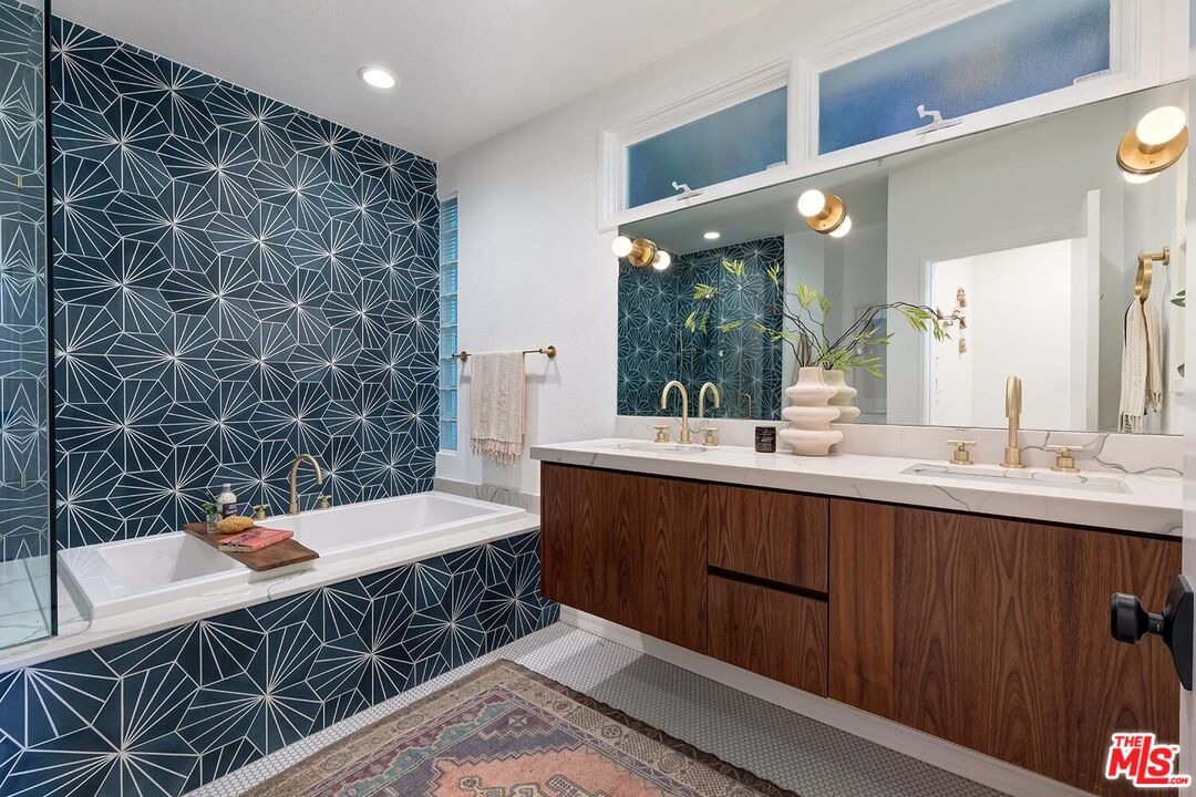 3002 3rd Street, Unit 203 Santa Monica, CA 90405 - Photo 35 of 44 a bathroom with a double vanity sink a mirror and a bathtub