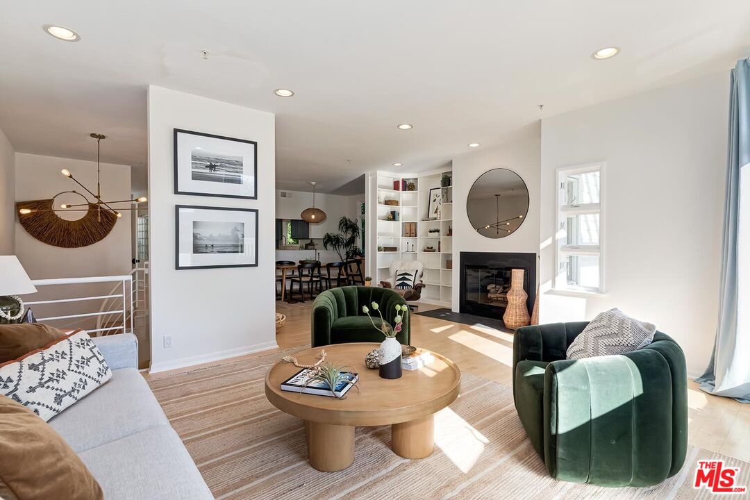 3002 3rd Street, Unit 203 Santa Monica, CA 90405 - Photo 5 of 44 a living room with furniture a fireplace and a window