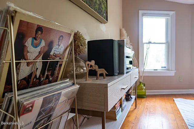 a living room with a bed and a window