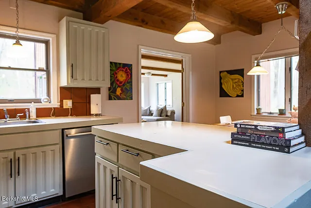 a view of a dining room with a table and chairs