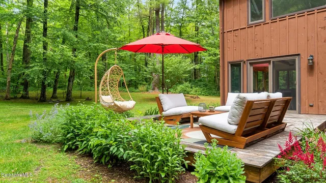 a view of a house with backyard sitting area and garden