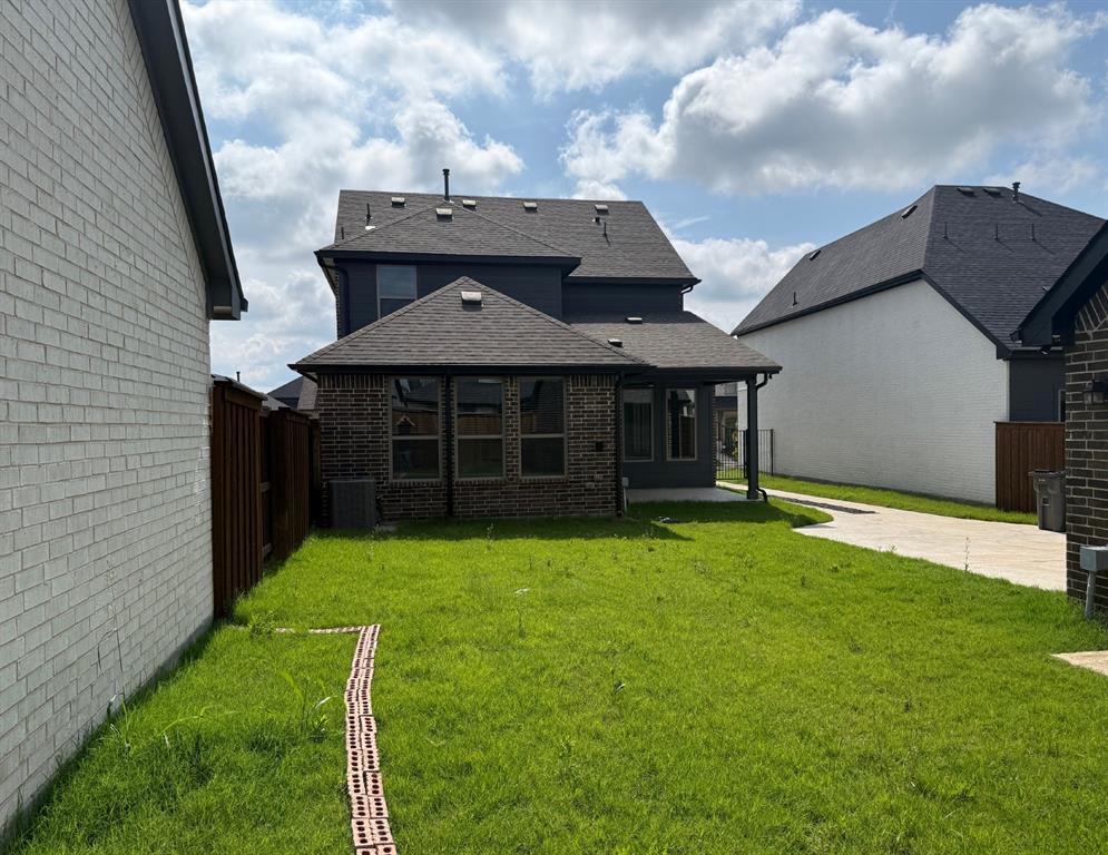 1840 Rosedale Avenue Van Alstyne, TX 75495 - Photo 23 of 24 Expansive green lawn with a covered patio and brick accents