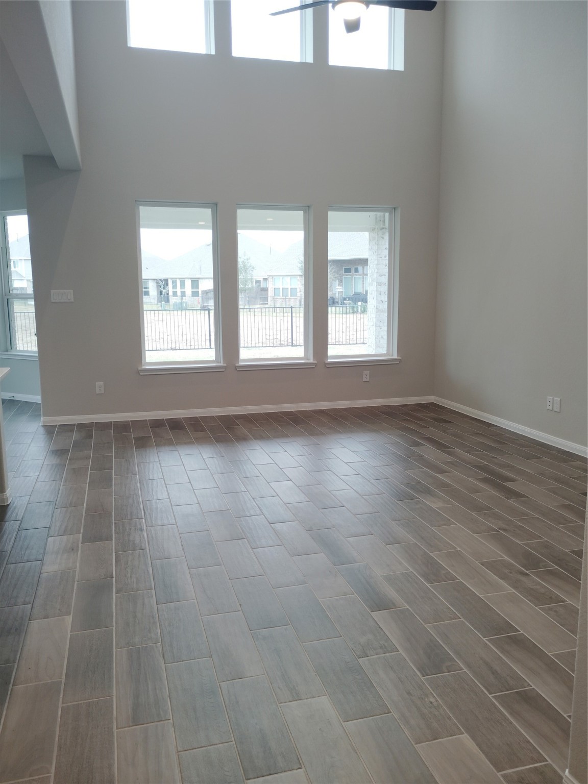 85 Carmel Drive Manvel, TX 77578 - Photo 25 of 31 an empty room with wooden floor and windows