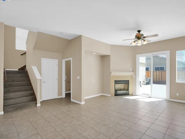 an empty room with fireplace and windows
