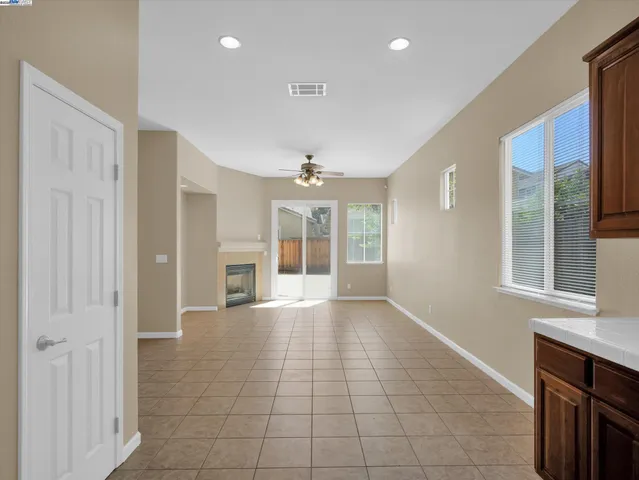 a view of an empty room with a kitchen