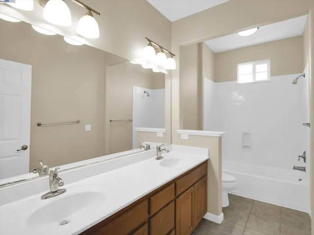 a bathroom with a sink vanity tub and a mirror
