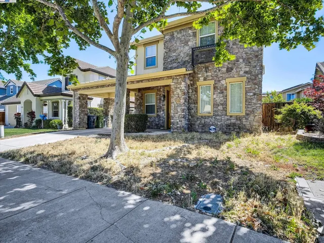 a view of a white house with a yard