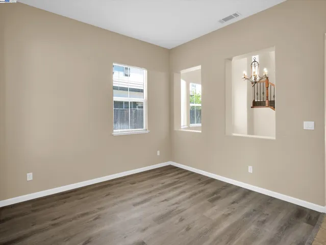 a view of a room with wooden floor and windows