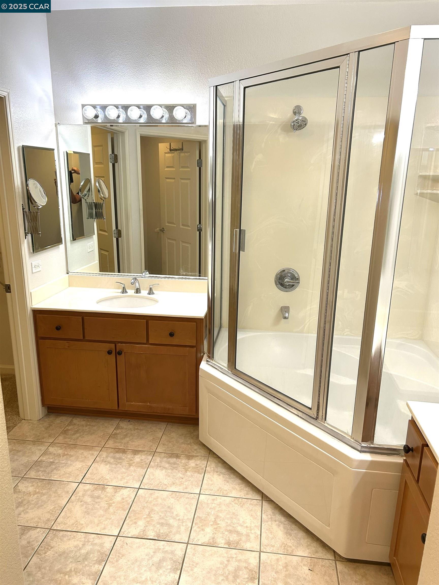 1310 Saddle Rack Street, Unit 352 San Jose, CA 95126 - Photo 12 of 41 a bathroom with a tub a sink a mirror and a shower