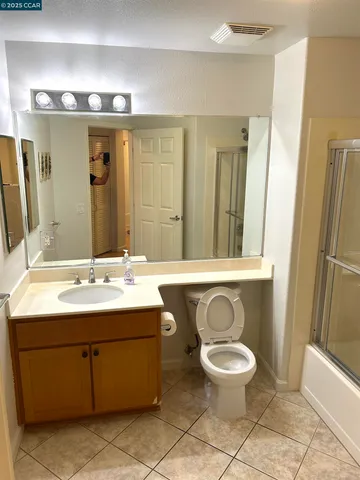 a bathroom with a glass shower door