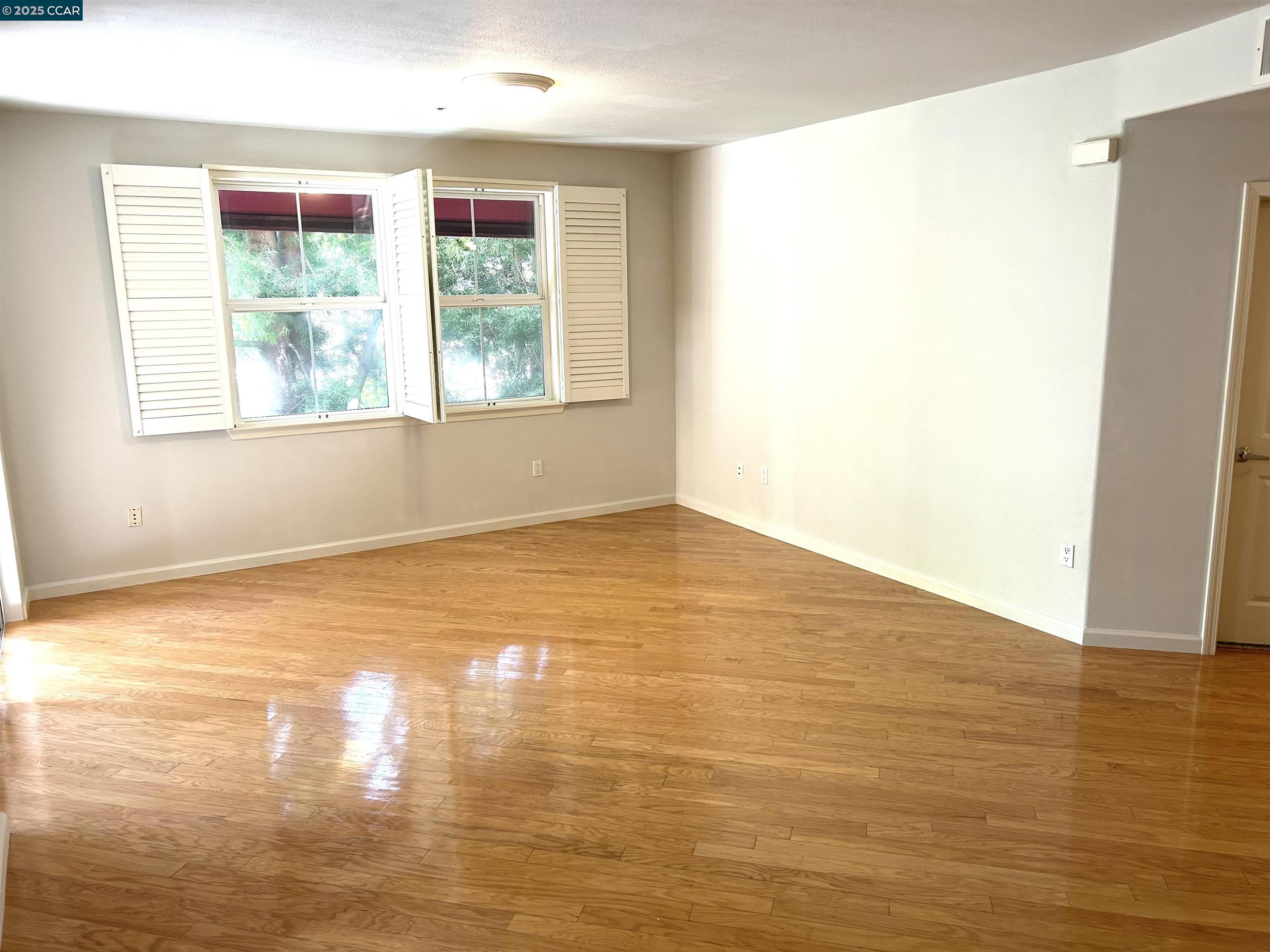 1310 Saddle Rack Street, Unit 352 San Jose, CA 95126 - Photo 3 of 41 a view of empty room with wooden floor and fan