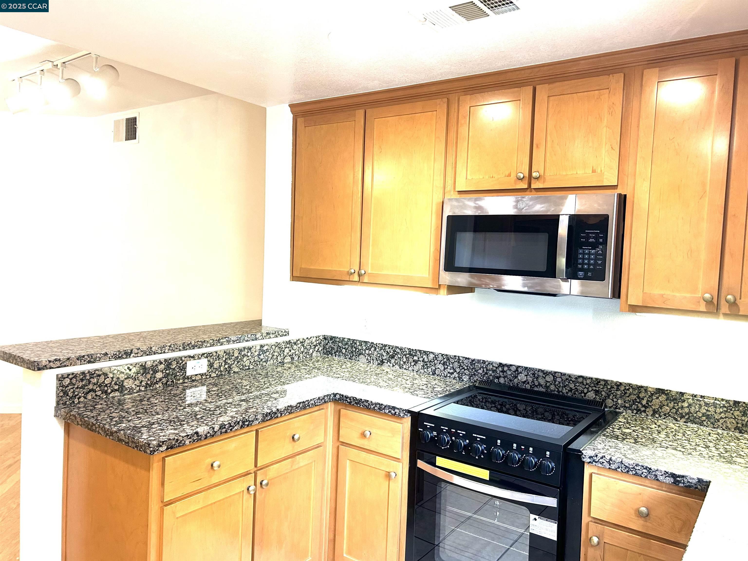 1310 Saddle Rack Street, Unit 352 San Jose, CA 95126 - Photo 7 of 41 a kitchen with a sink and a microwave