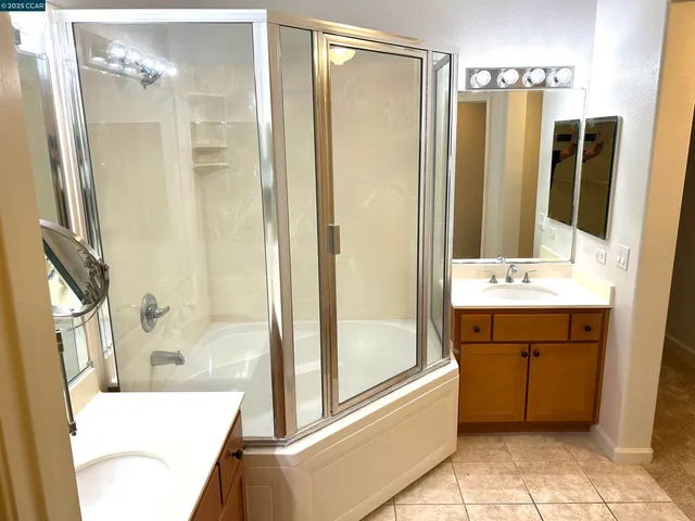 a bathroom with a sink a mirror and a shower