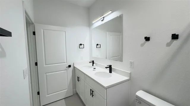 a bathroom with a sink and mirror