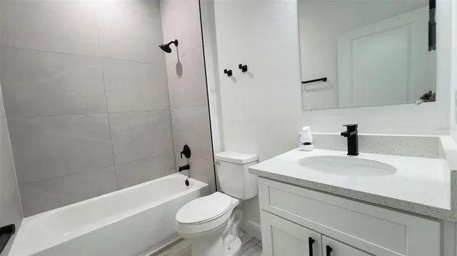 a bathroom with a sink a toilet and a bathtub