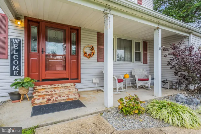 a view of front door of house with outdoor seating
