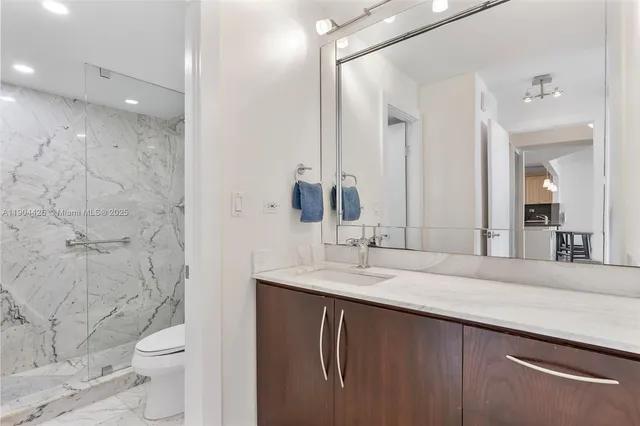a bathroom with a double vanity sink toilet and a mirror